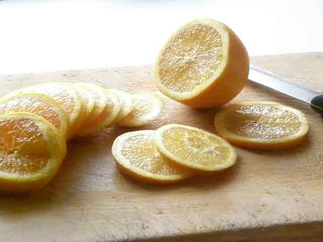 Cutting the oranges to be dehydrated for decorations at Big Mill B&B